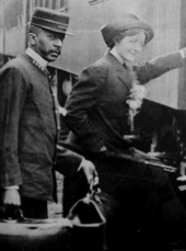 Pullman porter helping a woman.